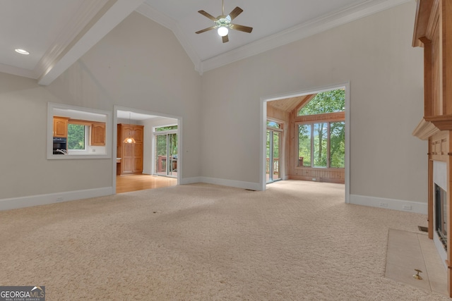 821 Carnellian Ln, Peachtree City, GA 30269 - unfurnished living room featuring crown molding, a ceiling fan, light colored carpet, a fireplace with flush hearth, and high vaulted ceiling