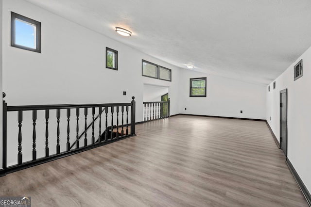 50 Hearthstone Dr, Newnan, GA 30263 - unfurnished room with vaulted ceiling and wood finished floors