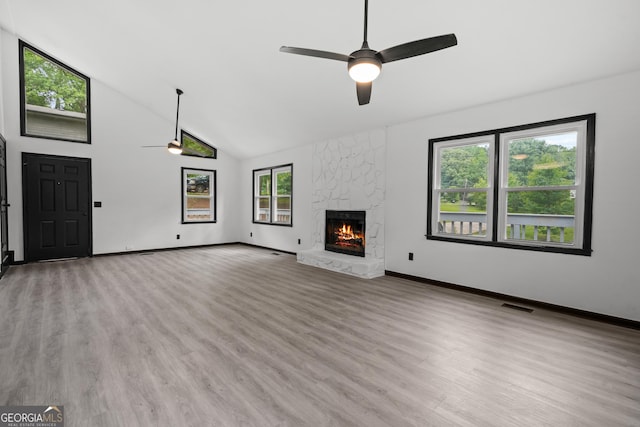 50 Hearthstone Dr, Newnan, GA 30263 - unfurnished living room with ceiling fan, high vaulted ceiling, a fireplace, and light wood-style floors