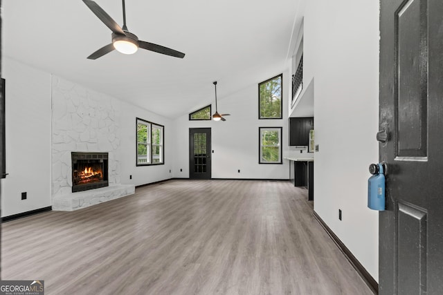 50 Hearthstone Dr, Newnan, GA 30263 - unfurnished living room featuring ceiling fan, a premium fireplace, high vaulted ceiling, and light wood-style floors