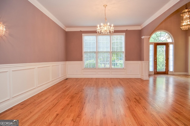 128 Laurel Ridge Dr, Alpharetta, GA 30004 - foyer entrance with a chandelier, a wainscoted wall, wood finished floors, crown molding, and a decorative wall