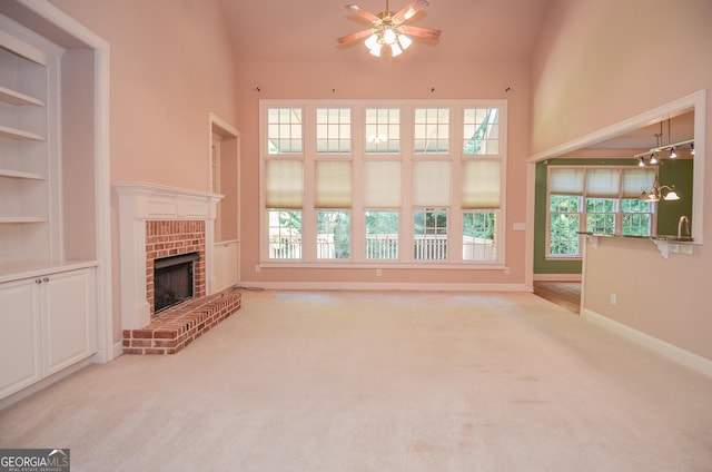 128 Laurel Ridge Dr, Alpharetta, GA 30004 - unfurnished living room with ceiling fan, carpet, a brick fireplace, high vaulted ceiling, and built in features