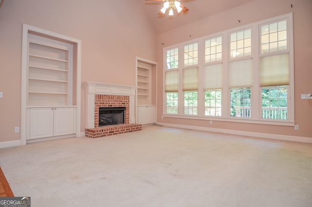 128 Laurel Ridge Dr, Alpharetta, GA 30004 - unfurnished living room featuring built in features, ceiling fan, a brick fireplace, plenty of natural light, and high vaulted ceiling