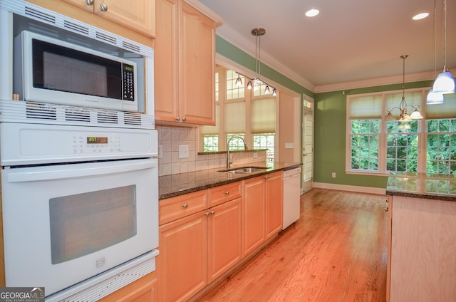 128 Laurel Ridge Dr, Alpharetta, GA 30004 - kitchen featuring white appliances, ornamental molding, light wood finished floors, a chandelier, and dark stone counters