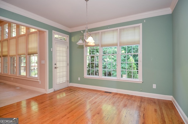 128 Laurel Ridge Dr, Alpharetta, GA 30004 - unfurnished dining area featuring a chandelier, wood finished floors, and crown molding