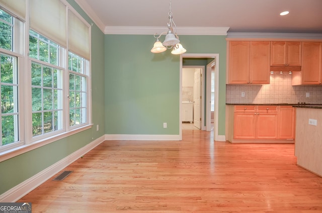 128 Laurel Ridge Dr, Alpharetta, GA 30004 - kitchen with a chandelier, dark countertops, crown molding, light wood finished floors, and tasteful backsplash