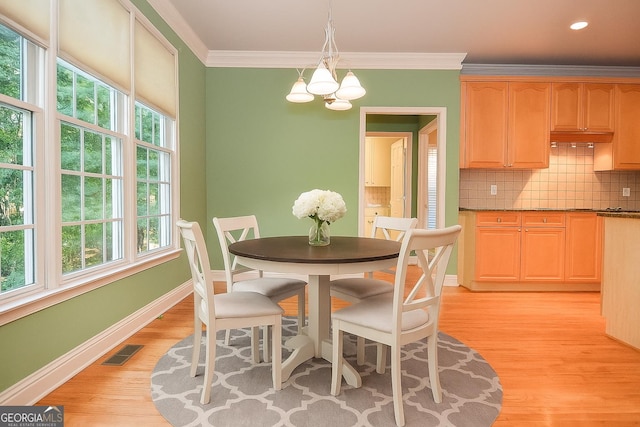 128 Laurel Ridge Dr, Alpharetta, GA 30004 - dining room with a chandelier, light wood-type flooring, plenty of natural light, and crown molding