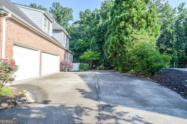 128 Laurel Ridge Dr, Alpharetta, GA 30004 - view of home's exterior featuring driveway, brick siding, and a garage