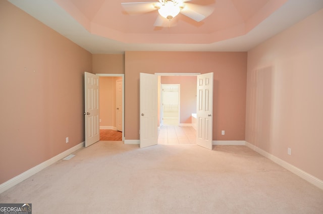 128 Laurel Ridge Dr, Alpharetta, GA 30004 - unfurnished bedroom with a tray ceiling, light colored carpet, ensuite bath, and a ceiling fan