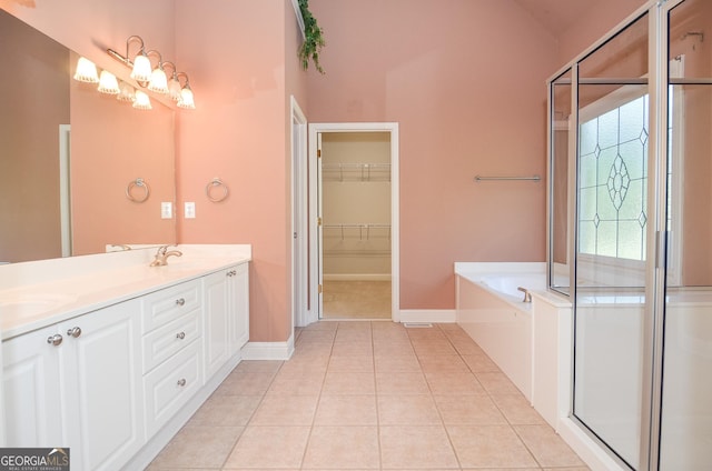 128 Laurel Ridge Dr, Alpharetta, GA 30004 - bathroom featuring a garden tub, double vanity, tile patterned flooring, a spacious closet, and a shower with shower door