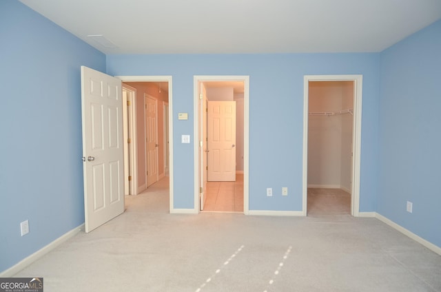 128 Laurel Ridge Dr, Alpharetta, GA 30004 - unfurnished bedroom featuring a walk in closet, carpet flooring, and a closet