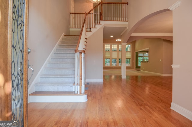 128 Laurel Ridge Dr, Alpharetta, GA 30004 - staircase featuring wood finished floors, arched walkways, and a high ceiling