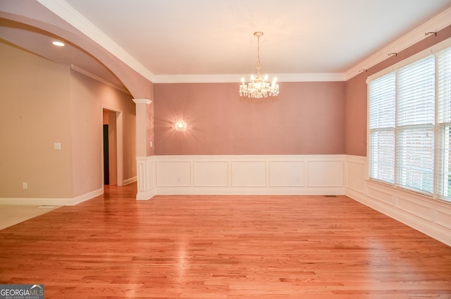 128 Laurel Ridge Dr, Alpharetta, GA 30004 - unfurnished room featuring arched walkways, light wood-type flooring, ornamental molding, a chandelier, and ornate columns