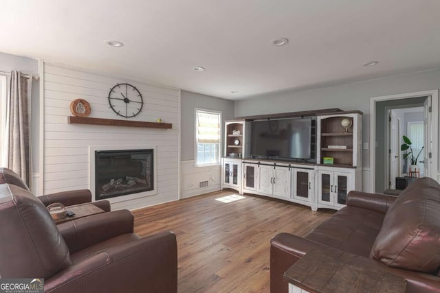 1908 Musket Ct, Stone Mountain, GA 30087 - living area featuring a large fireplace, wood finished floors, and recessed lighting