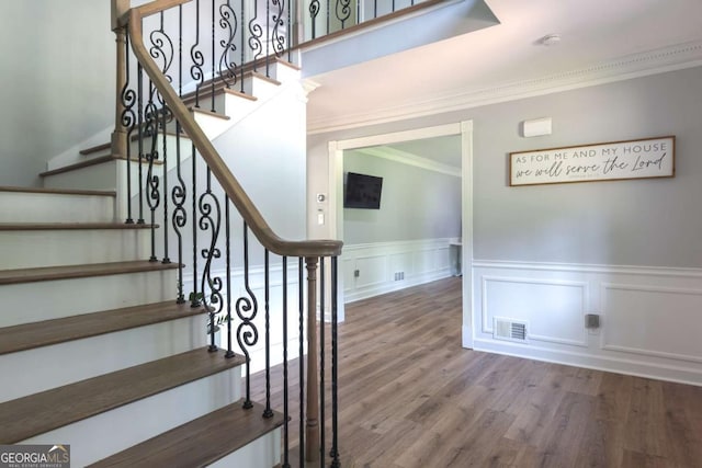 1908 Musket Ct, Stone Mountain, GA 30087 - stairway featuring crown molding, wainscoting, wood finished floors, and a decorative wall