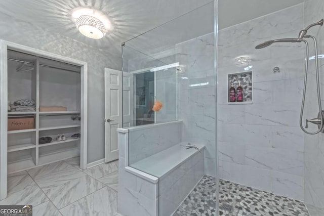 1908 Musket Ct, Stone Mountain, GA 30087 - bathroom with a tile shower, a spacious closet, and marble finish floors