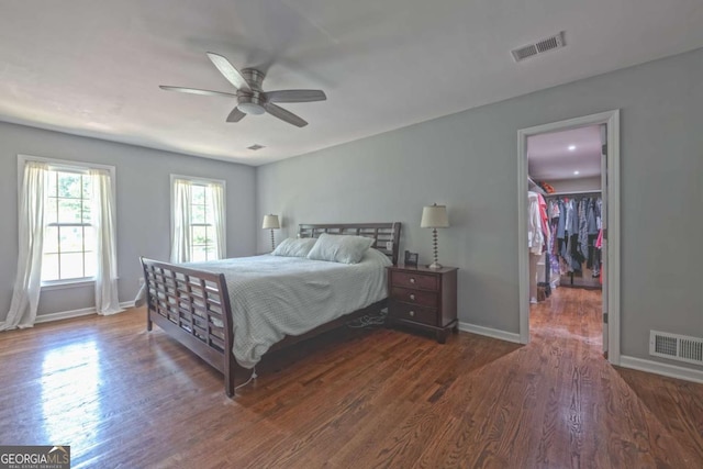 1908 Musket Ct, Stone Mountain, GA 30087 - bedroom featuring wood finished floors, a spacious closet, ceiling fan, and a closet