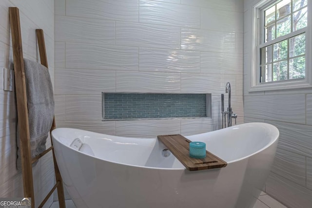 1908 Musket Ct, Stone Mountain, GA 30087 - full bathroom with tile walls and a freestanding tub