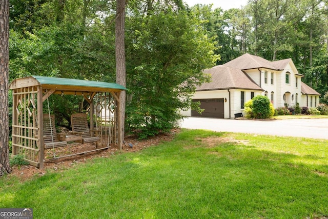 1908 Musket Ct, Stone Mountain, GA 30087 - view of green lawn featuring a garage and concrete driveway