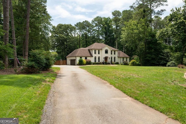 1908 Musket Ct, Stone Mountain, GA 30087 - view of front of home featuring driveway, a garage, and a front lawn