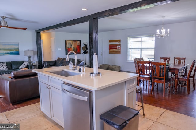 9782 Ga Highway 112, Rochelle, GA 31079 - kitchen featuring stainless steel dishwasher, open floor plan, white cabinetry, a chandelier, and light countertops