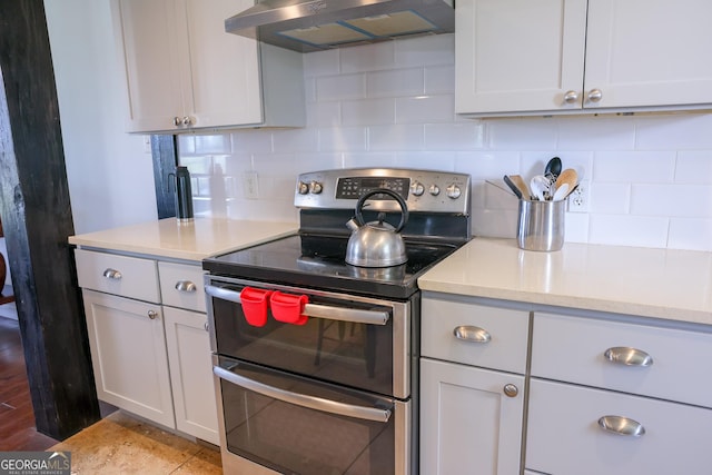 9782 Ga Highway 112, Rochelle, GA 31079 - kitchen featuring double oven range, ventilation hood, light countertops, and decorative backsplash