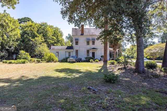67 Main St, Lumpkin, GA 31815 - rear view of house with a chimney and a yard