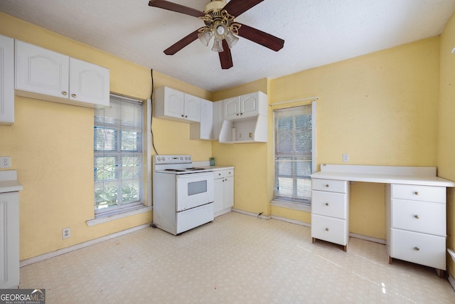 67 Main St, Lumpkin, GA 31815 - kitchen featuring electric stove, white cabinets, ceiling fan, light floors, and light countertops
