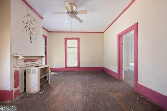 67 Main St, Lumpkin, GA 31815 - empty room with hardwood / wood-style flooring, crown molding, ceiling fan, and a wood stove