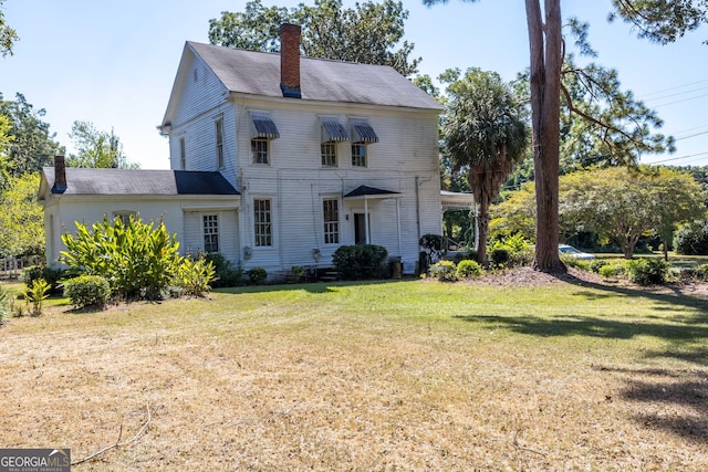 67 Main St, Lumpkin, GA 31815 - view of front of house with a chimney and a front lawn