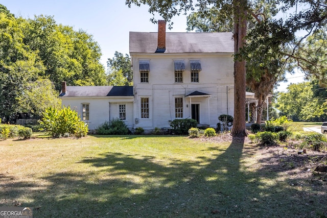 67 Main St, Lumpkin, GA 31815 - view of front of house featuring a chimney and a front lawn