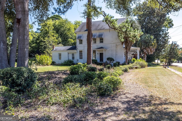67 Main St, Lumpkin, GA 31815 - view of front facade with a front yard and a chimney