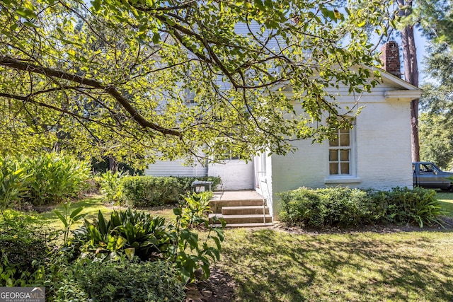 67 Main St, Lumpkin, GA 31815 - view of property hidden behind natural elements featuring brick siding and a chimney
