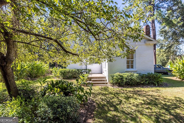 67 Main St, Lumpkin, GA 31815 - view of front of house with a chimney, a front lawn, and brick siding