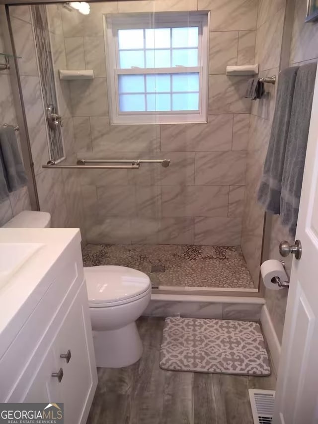 121 N Church St Unit 101, Clayton, GA 30525 - full bathroom with vanity, a stall shower, and wood finished floors