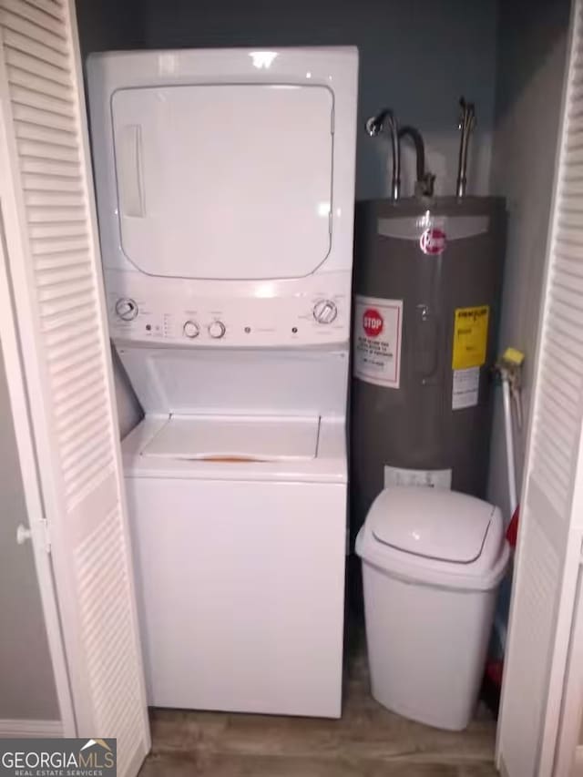 121 N Church St Unit 101, Clayton, GA 30525 - laundry room featuring electric water heater and stacked washer / dryer