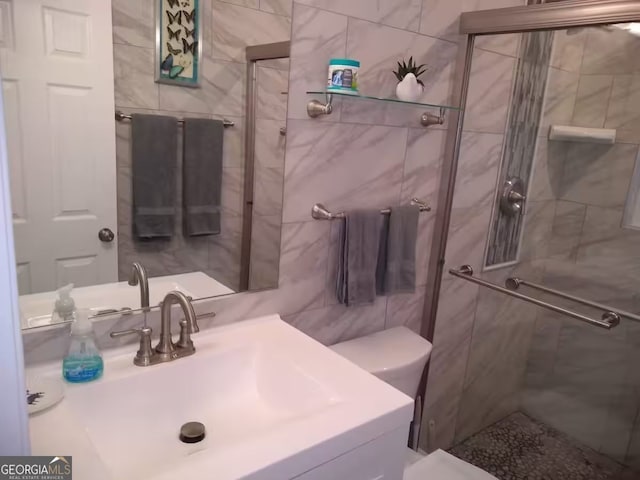 121 N Church St Unit 101, Clayton, GA 30525 - bathroom with a shower stall, vanity, and tile walls