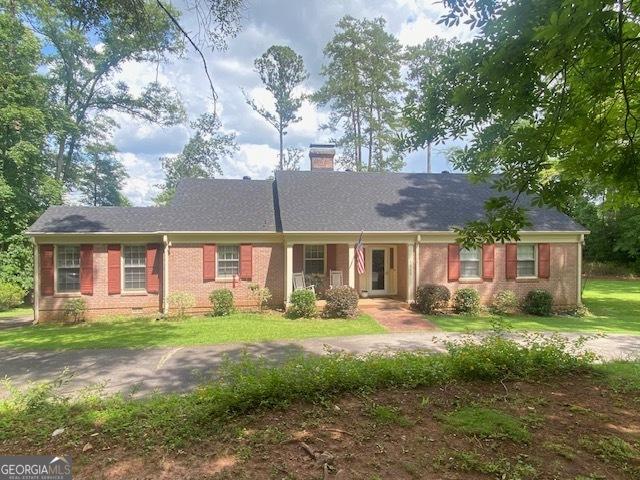 1812 Morgan Cantey Dr, Lanett, AL 36863 - ranch-style house featuring a chimney, brick siding, and a front yard