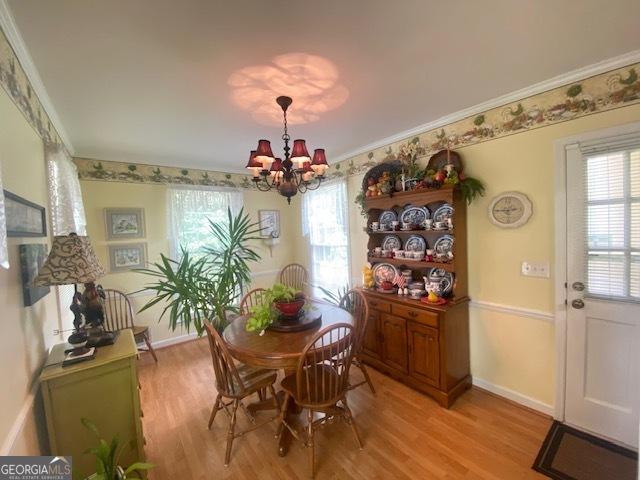 1812 Morgan Cantey Dr, Lanett, AL 36863 - dining room featuring light wood-style flooring, a chandelier, and crown molding