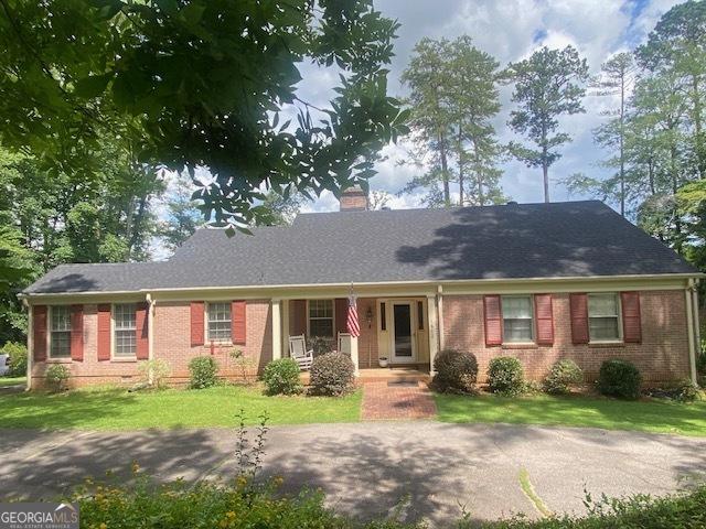 1812 Morgan Cantey Dr, Lanett, AL 36863 - ranch-style house featuring brick siding, a chimney, and a front yard