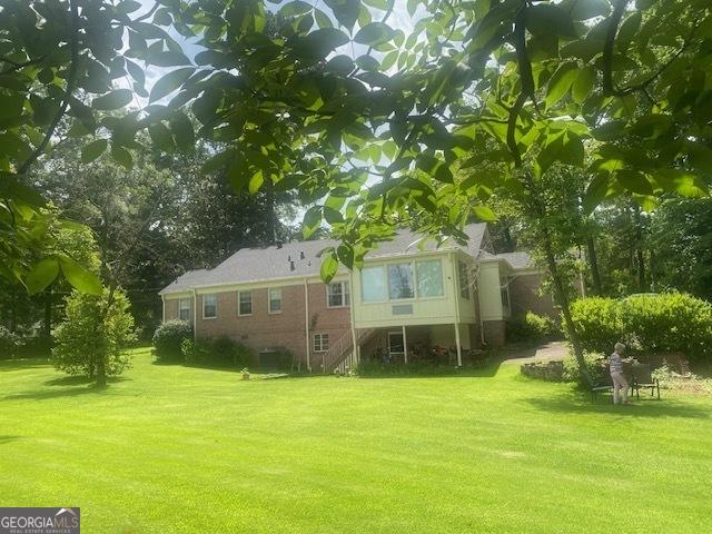 1812 Morgan Cantey Dr, Lanett, AL 36863 - rear view of house with a yard