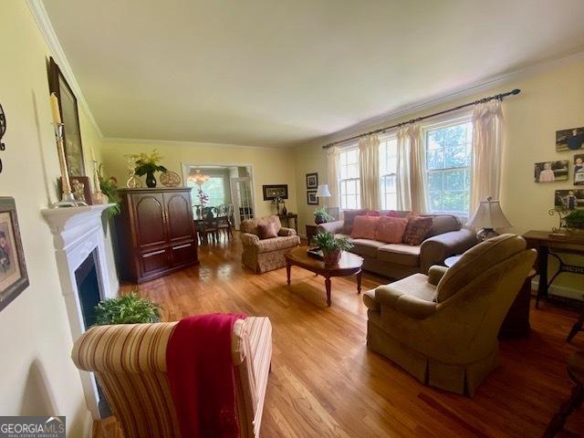 1812 Morgan Cantey Dr, Lanett, AL 36863 - living room with wood finished floors, ornamental molding, and a fireplace