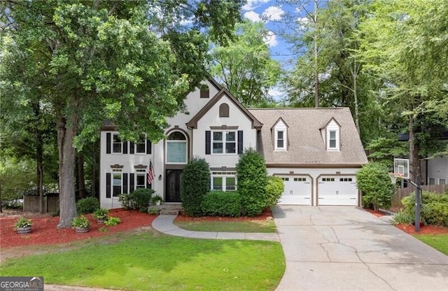 4300 May Apple Dr, Alpharetta, GA 30005 - view of front facade with concrete driveway, an attached garage, a front lawn, and stucco siding