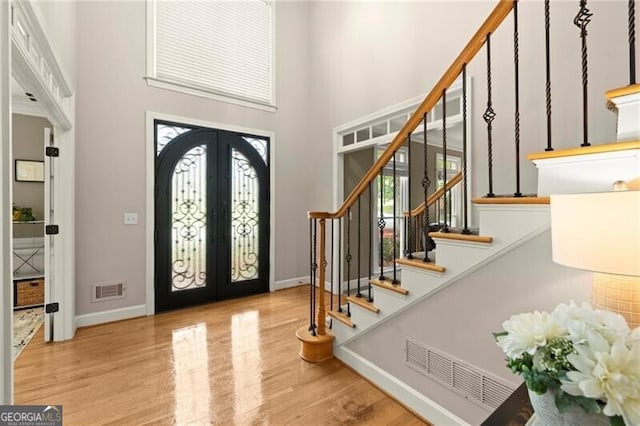 4300 May Apple Dr, Alpharetta, GA 30005 - entryway featuring french doors, a high ceiling, stairs, and wood finished floors