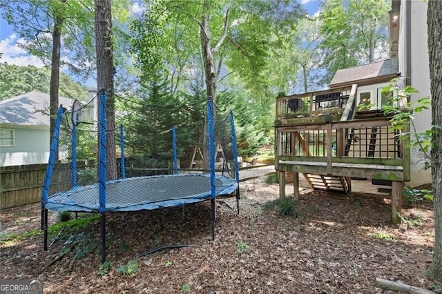4300 May Apple Dr, Alpharetta, GA 30005 - view of yard with a trampoline and a wooden deck