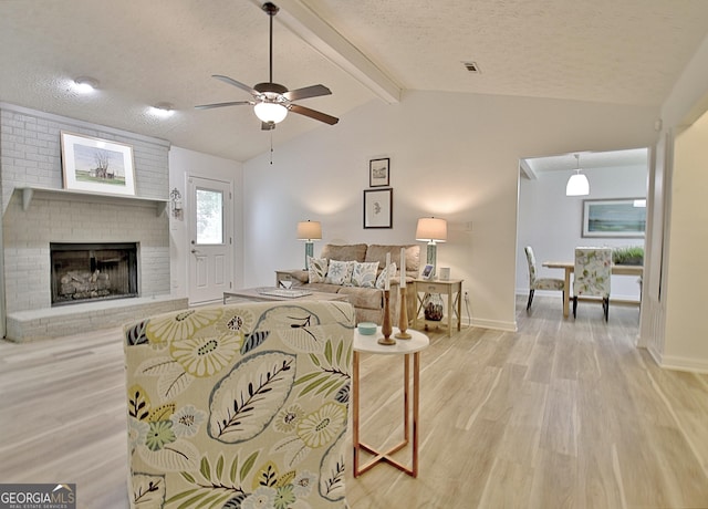 210 Grandchester Way, Fayetteville, GA 30215 - living area featuring light wood-style floors, a ceiling fan, a textured ceiling, and a brick fireplace