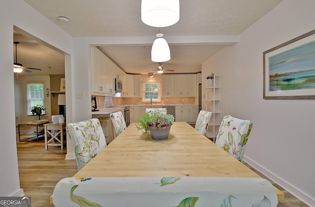 210 Grandchester Way, Fayetteville, GA 30215 - dining area with ceiling fan, plenty of natural light, light wood-type flooring, beam ceiling, and a textured ceiling