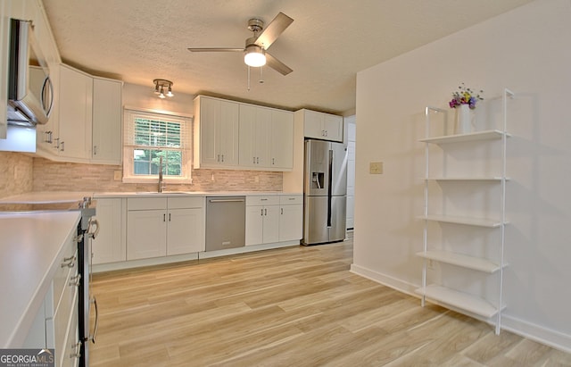 210 Grandchester Way, Fayetteville, GA 30215 - kitchen with stainless steel appliances, ceiling fan, tasteful backsplash, white cabinets, and light countertops