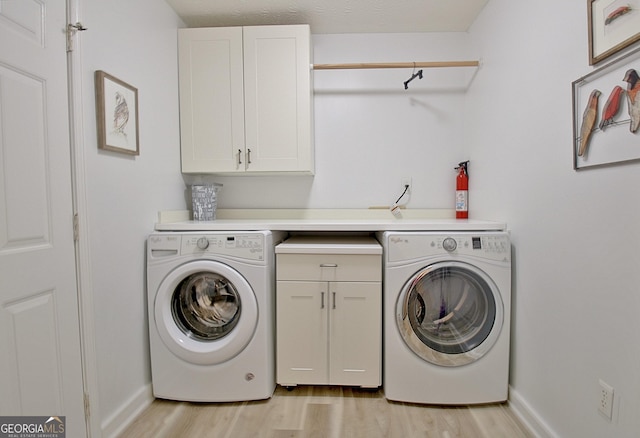 210 Grandchester Way, Fayetteville, GA 30215 - laundry area featuring washer / dryer, cabinet space, and light wood finished floors