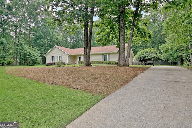 210 Grandchester Way, Fayetteville, GA 30215 - ranch-style house with driveway, a front lawn, and view of scattered trees